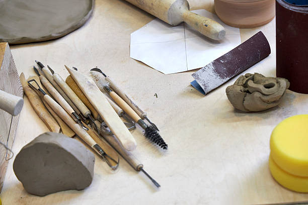 istock view of a wooden table in the workshop with pottery tools and clay, view from above 2209122826