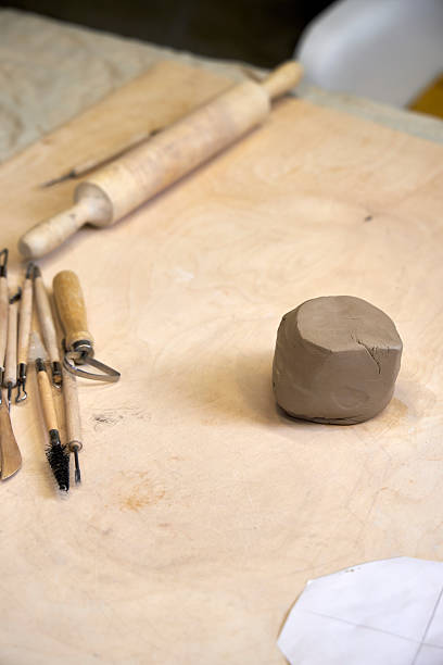 istock On a wooden table there is a piece of clay and tools for cutting and rolling clay 2209122949