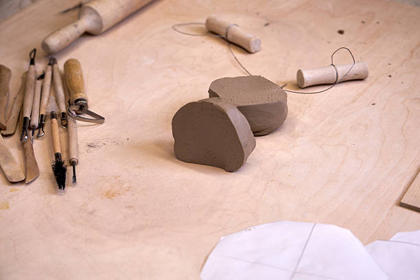 istock On a wooden table there is a piece of clay and tools for cutting and rolling clay 2209122964