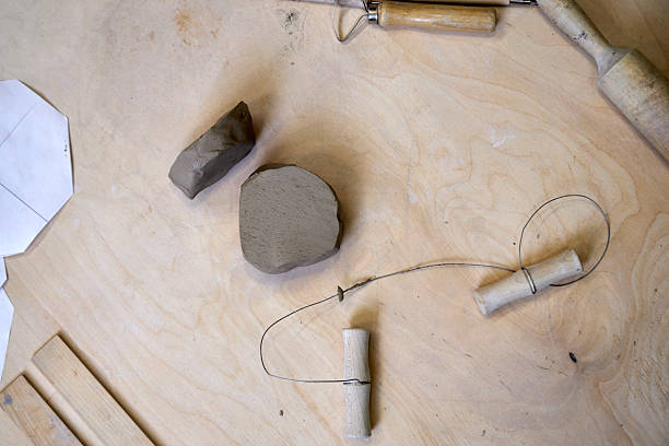istock On a wooden table there is a piece of clay and tools for cutting and rolling clay 2209122977