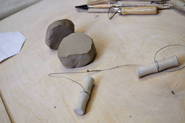 istock On a wooden table there is a piece of clay and tools for cutting and rolling clay 2209122995