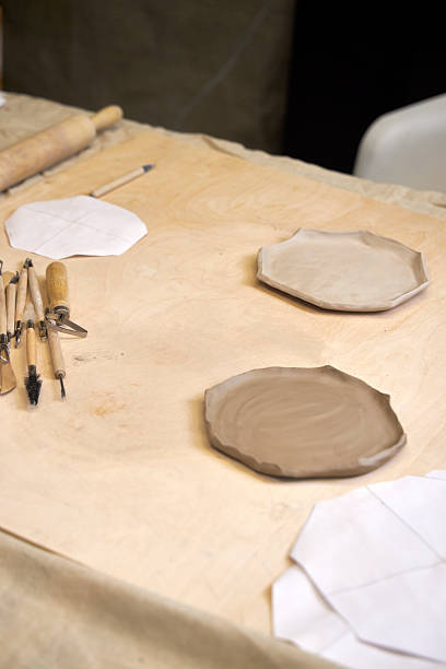 istock on a wooden table there is a blank for a handmade clay plate and tools for clay processing 2209123002