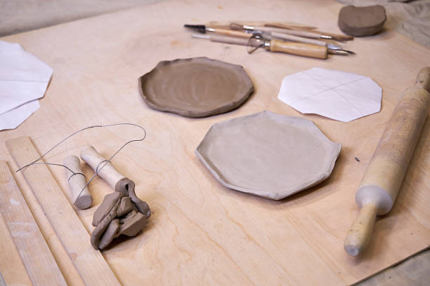 istock on a wooden table there is a blank for a handmade clay plate and tools for clay processing 2209123018