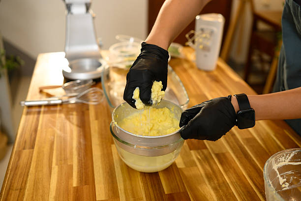 istock Man squeezing homemade butter to extract fresh buttermilk in a cozy kitchen 2209123306