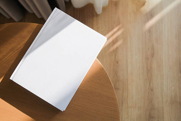 blank book mockup on wooden coffee table , shadow overlay