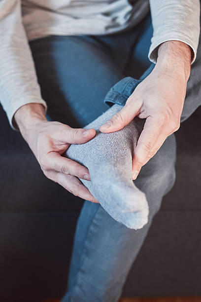 istock Man with ankle and foot pain at home. 2209124945