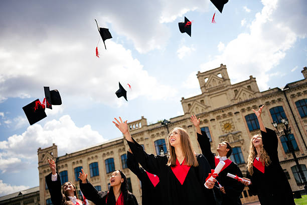 istock Joyful graduates celebrate outdoors, throwing mortarboards skyward, marking the conclusion of their college journey on a vibrant summer day. 2209126230