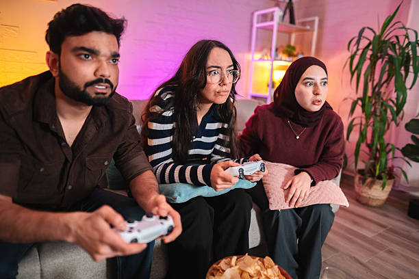 istock Concentrated friends playing video games at home 2209126338