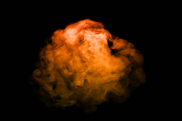 Orange smoke effect floating on black background. Abstract bright and intense background. Fog or smoke.