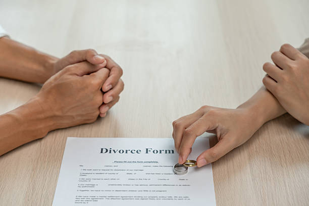 istock Quarrel, Divorce. husband and wife remove married ring. Couples desperate and disappoint after marriage. Divorce document, upset and frustrated after conflict. distrust, love problems, betrayals 2209128439