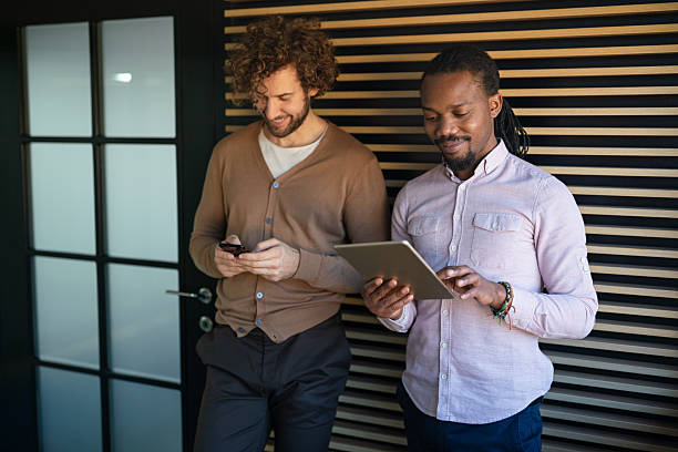 istock Group of young multi-ethnic startup business team collaborating on project in modern office 2209129516