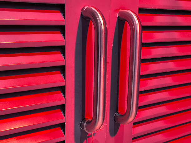 istock Close Up of Red Shutter Doors with Handles 2209129790