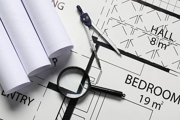 istock Dividers and magnifying glass on different architectural drawings, top view 2209133542