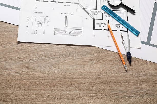 istock Different engineering drawings, pencil, dividers, ruler and magnifying glass on wooden table, flat lay 2209133559