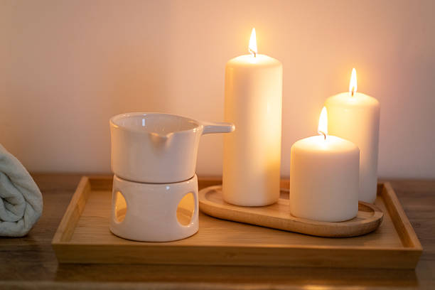 istock Atmospheric, burning candles and an essential oil warmer, creating a warm, relaxing home spa ambiance 2209133701