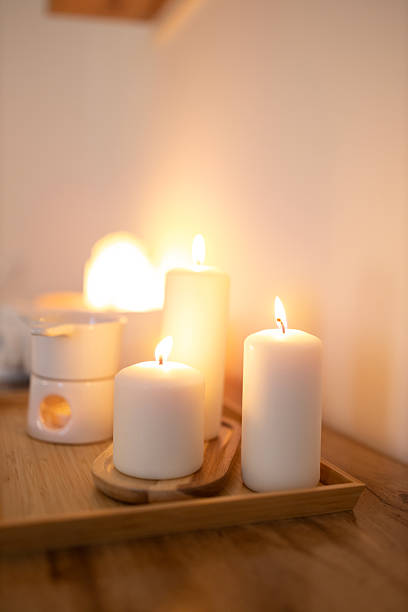 istock Atmospheric, burning candles and an essential oil warmer, creating a warm, relaxing home spa ambiance 2209133892