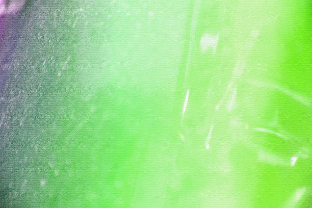 Abstract background with a blend of green and purple hues, creating a soft and dreamy atmosphere with light and shadow