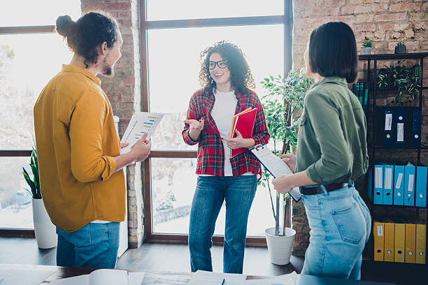 istock Young colleagues collaborating in modern office space with casual attire 2209136226