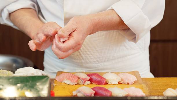 istock The hands of a chef preparing sushi 2209136794
