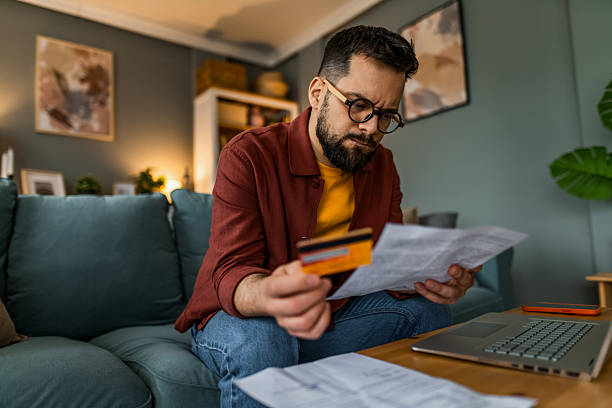 istock Displeased man having problems with paying financial bills at home 2209136832