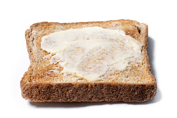 istock Sliced fresh bread and butter isolated on white background 2209137472
