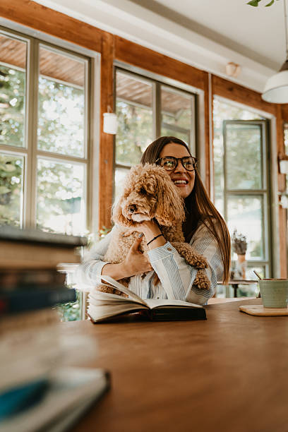 istock Beautiful Young Woman with Poodle at Cafe 2209138848