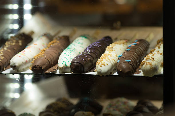 Sweet Treats on Display in a Shop Window at Night.