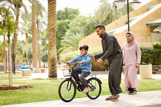 istock Boy learning to ride bicycle with support of father 2209144197