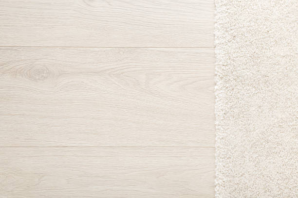 istock White new fluffy home carpet on light color laminate floor background. Closeup. Empty place for text. Top down view. 2209148632