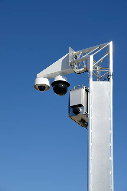 istock Surveillance cameras mounted on the pole with blue sky 2209149916