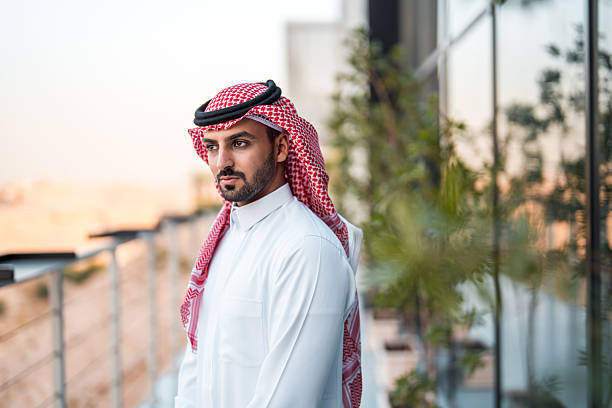 istock Confident Middle Eastern Businessman in White Thobe on Modern Office Balcony 2209151607