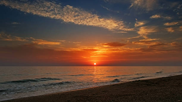 istock Sunset over sea with vibrant colors 2209156113
