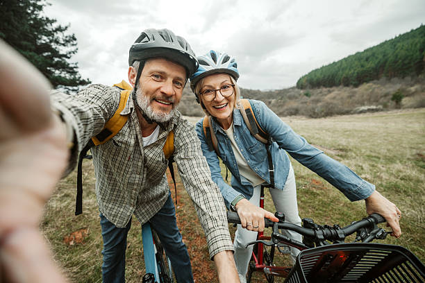 istock Mature couple taking selfie during cycling break in forest 2209156810