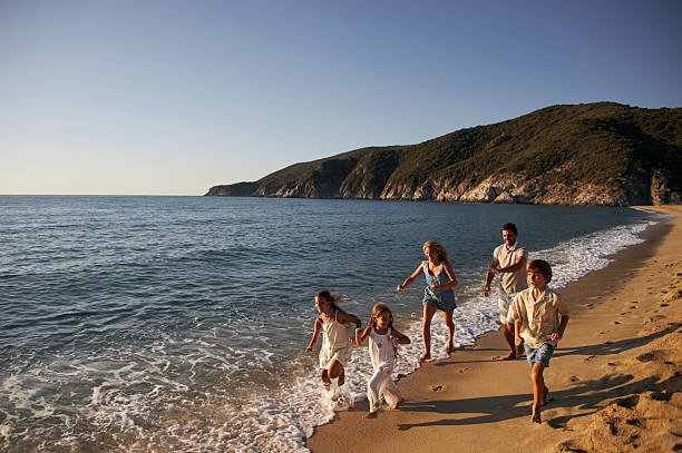 istock A family run down a tropical paradise beach during sunrise 2209157860