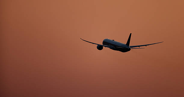 Silhouette of an airplane taking off at sunset with a beautiful sunset background, symbolizing hopes and Dreams take off.