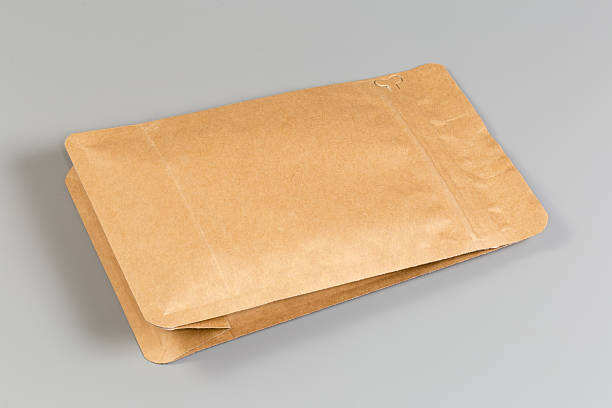 istock Small sealed paper packing bag with dry products 2209158135