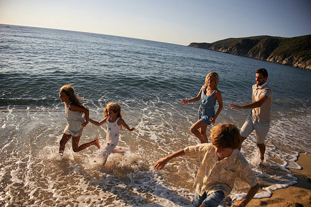istock A family run down a tropical paradise beach during sunrise 2209158235
