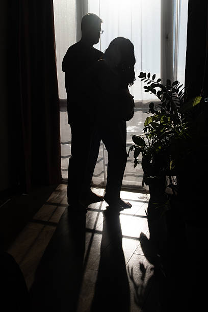 istock Intimate Moment of Expecting Parents by the Window 2209158334
