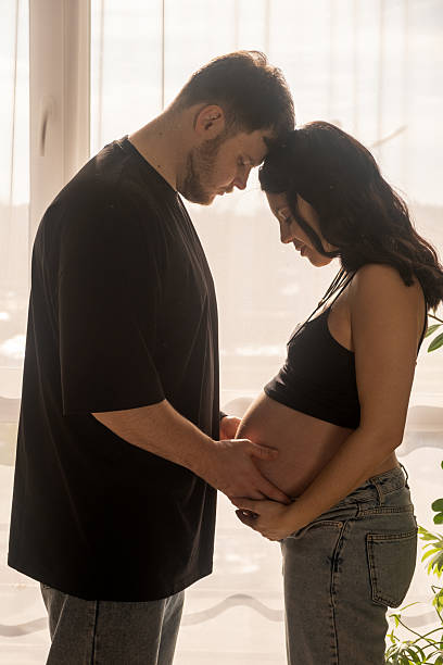 istock Intimate Moment of Expecting Parents by the Window 2209158341