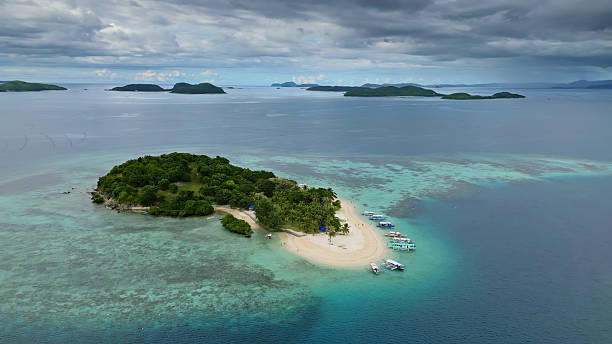 istock Small tropical island surrounded by distant islands 2209158532