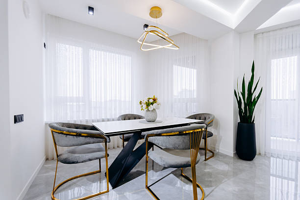 istock A dining room featuring a table, chairs, and a decorative potted plant 2209160180