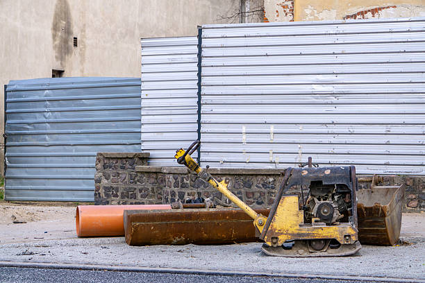 istock An abandoned compactor against the backdrop of a makeshift construction site fence – a shot of the city's infrastructure during renovation work 2209161021