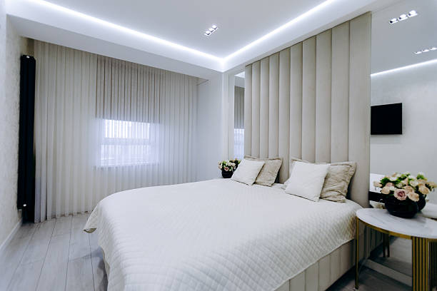 istock Cozy bedroom with a comfortable bed, nightstand, mirror, and TV 2209161161