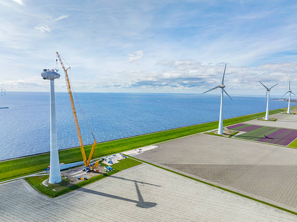 istock Wind turbine construction with huge cranes at a wind park 2209161859