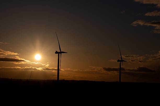 istock Wind turbines silhouetted against a sunset sky. 2209161976