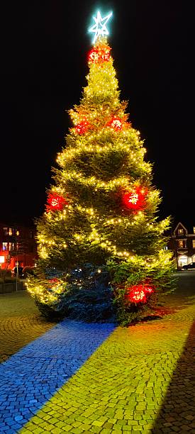 istock Illuminated Christmas Tree with festive lights and the yellow-blue flag 2209162074