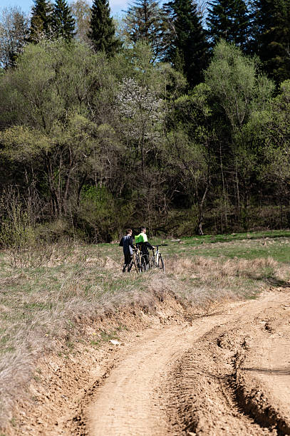 istock Two cyclists pause on a dirt path, enjoying the spring scenery. 2209163135