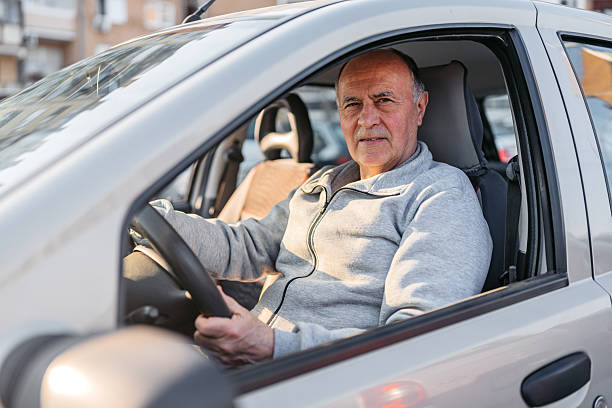 istock Senior Man Sitting On The Driver's Side In The Car 2209163202
