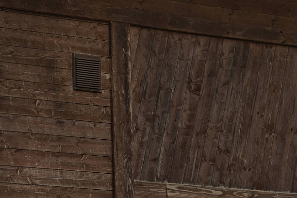 istock A rustic wooden wall featuring a vent and a sliding door design element 2209163932