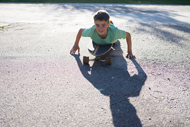 Mid adult woman lying down on longboard skate and relaxing